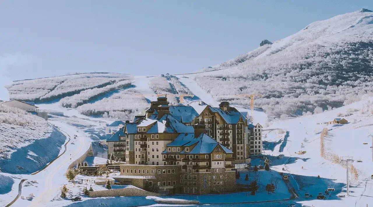 Snow-covered resort buildings beneath frosted mountain slopes